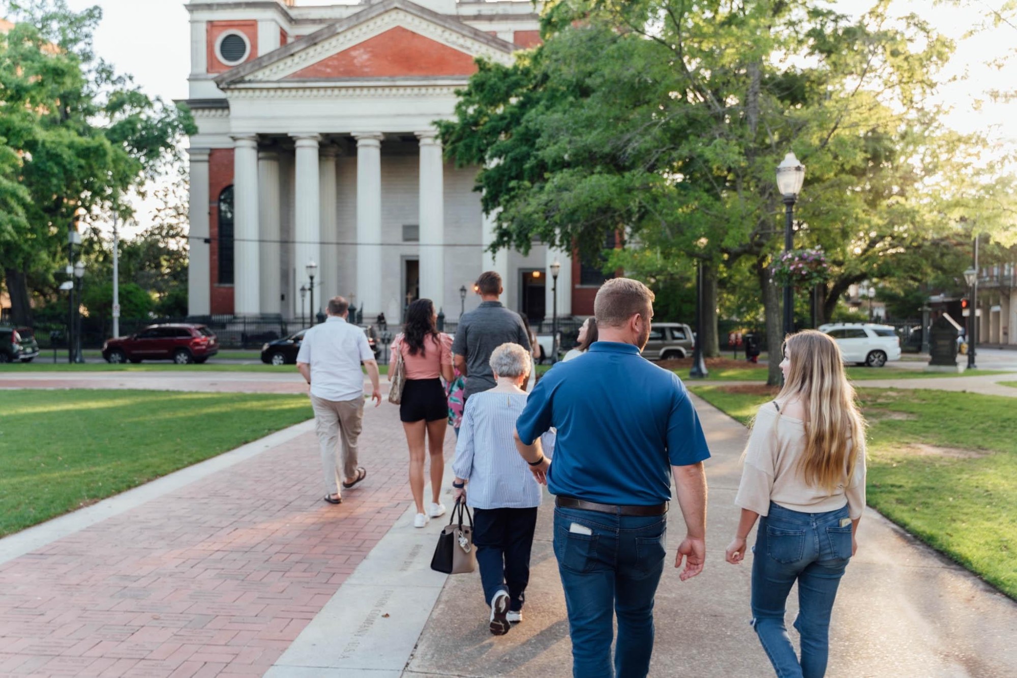 a group of people walking on a sidewalk
