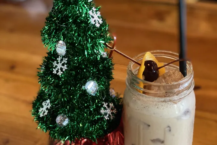 a bottle of wine sitting on top of a wooden cutting board
