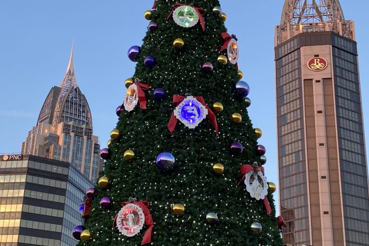 a group of people flying kites in front of a building