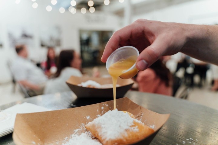 a close up of a person cutting a piece of cake on a table
