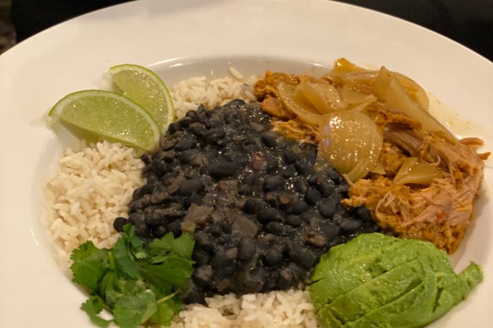 a plate of food with rice meat and vegetables