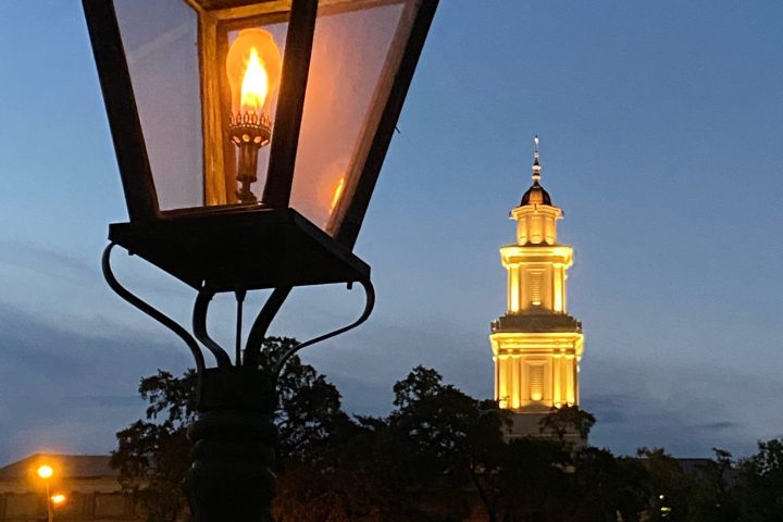 a large clock tower towering over the city at night