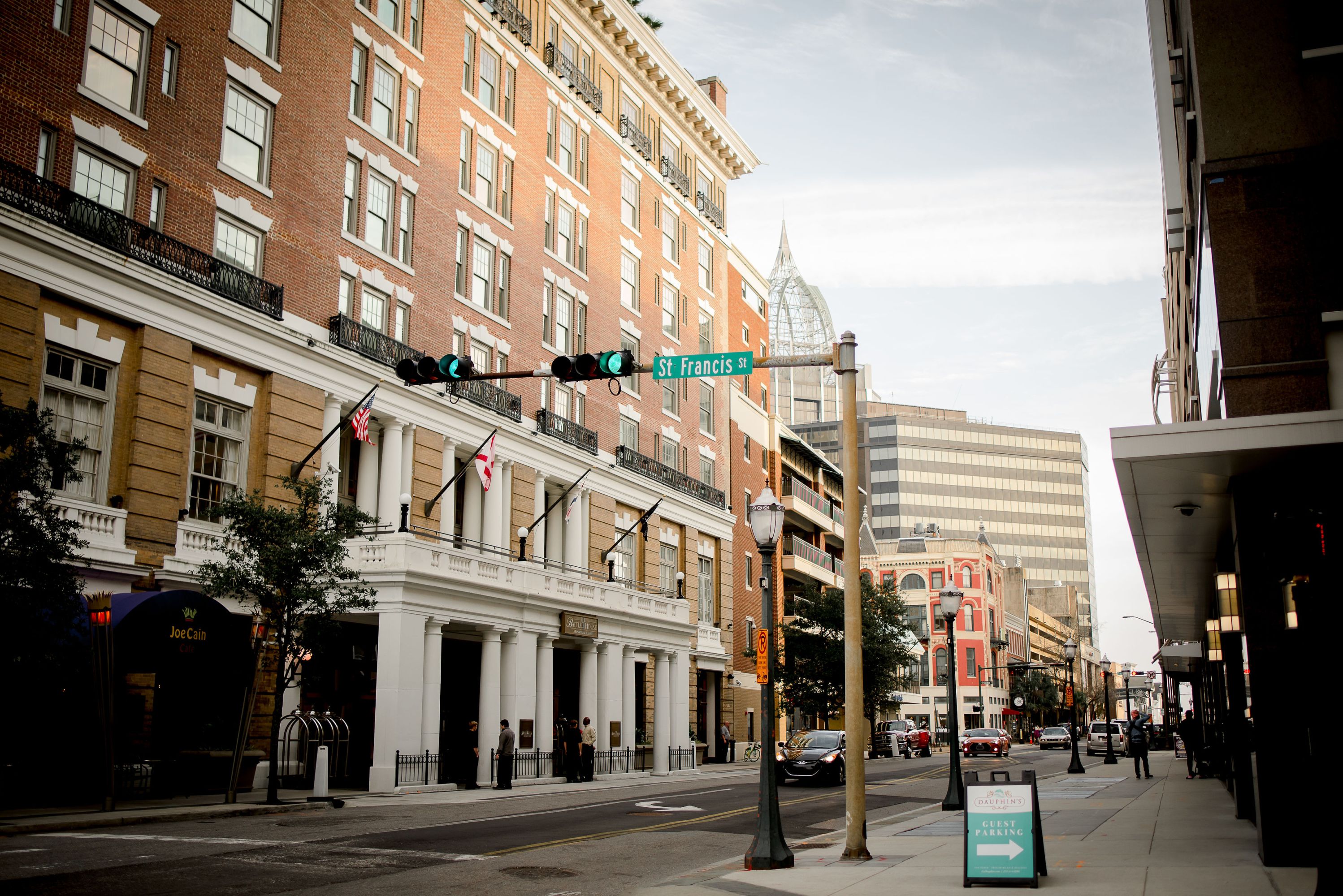Urban street with historic buildings and traffic lights.