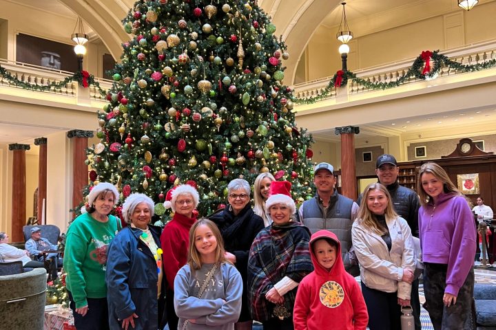 a group of people standing in front of a crowd posing for the camera