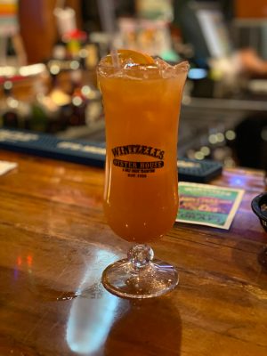 a glass of orange juice next to a cup of coffee on a table