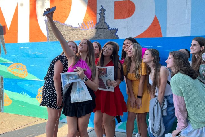 a group of people standing in front of a crowd posing for the camera