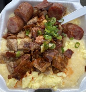 a plate of food with rice meat and vegetables