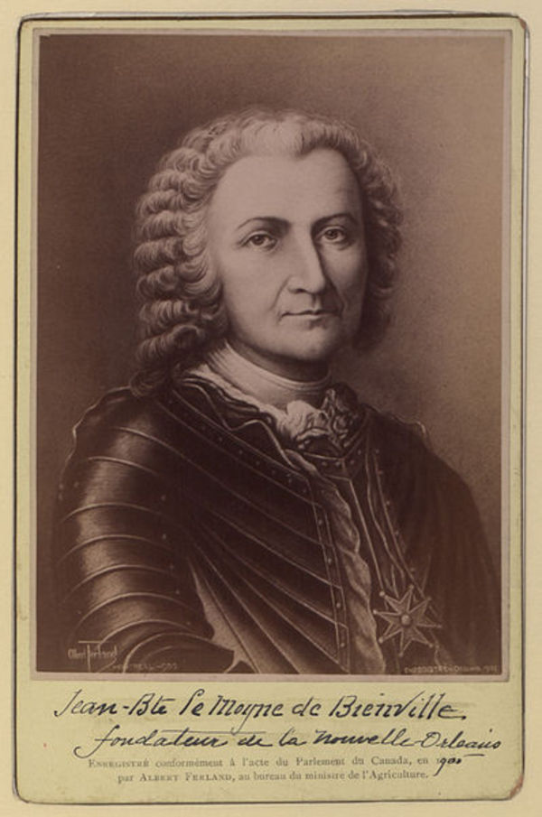 Sepia portrait of a man with curly hair in historical attire.